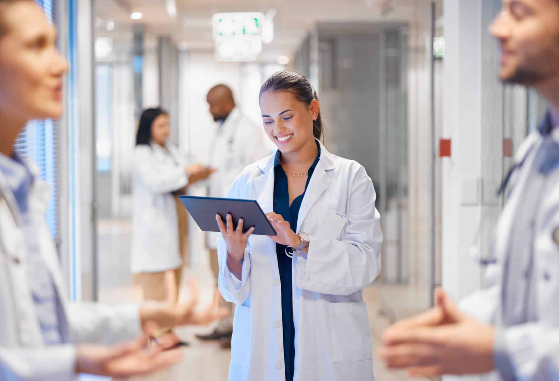 Happy,Woman,Doctor,On,Tablet,For,Employees,Management,,Hospital,Workflow